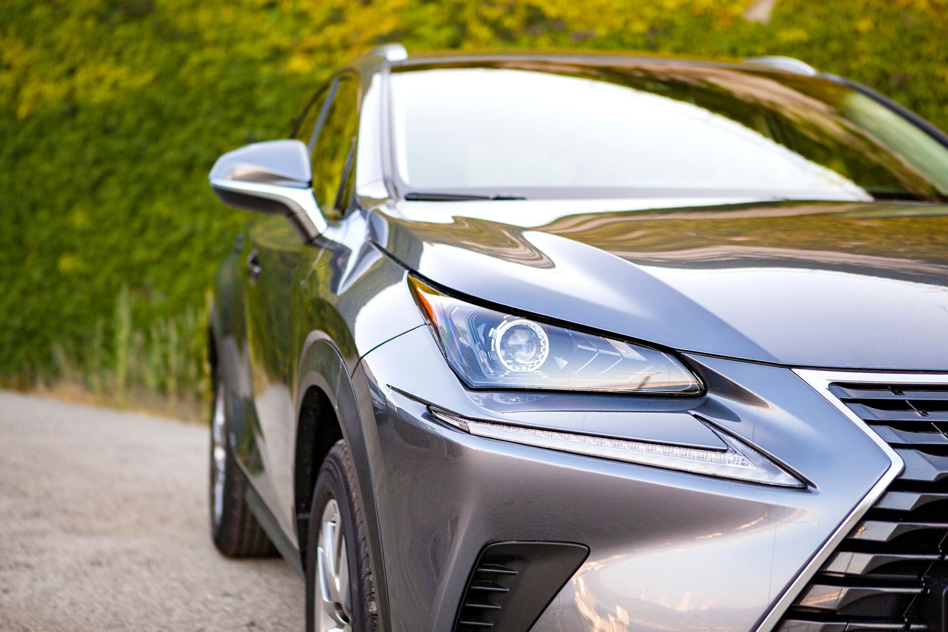 Close up Summer image in front of the luxury sport silver car with green wall in the back. Cars For Sale Stock. Car Dealer Inventory Close up Summer image in front of the luxury sport silver car with green wall in the back. Cars For Sale Stock. Car Dealer Inventory